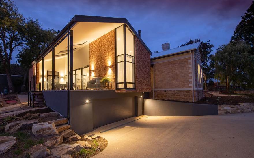 Web design for construction and remodeling companies, shown with a modern home at dusk
