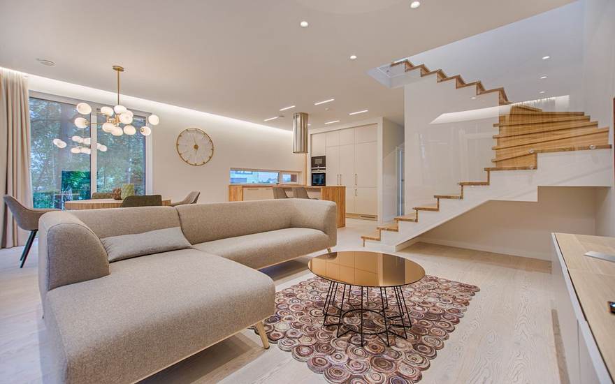 Web design for real estate, shown with a bright living room and staircase